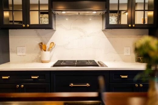 Charleene's-Houses-MD-baltimore-towson-kitchen-renovation-dark-black-cabinets-brass-cabinet-hardware-marble-backsplash