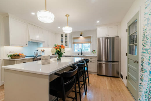 Charleene's-Houses-baltimore-MD-kitchen-renovation-beige-cabinets-beige-island-black-faucet-brass-hanging-island-pendants-open-concept-kitchen
