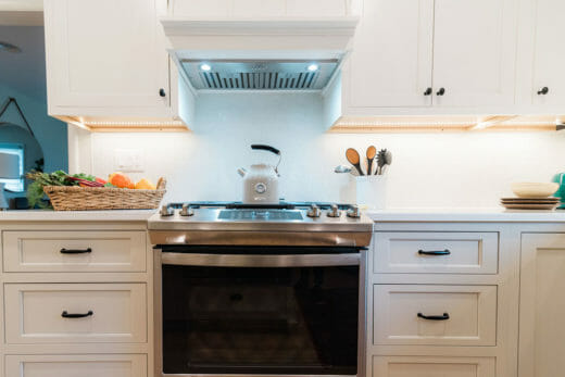 Charleene's-Houses-baltimore-MD-kitchen-renovation-beige-cabinets-black-cabinet-hardware-range-hood
