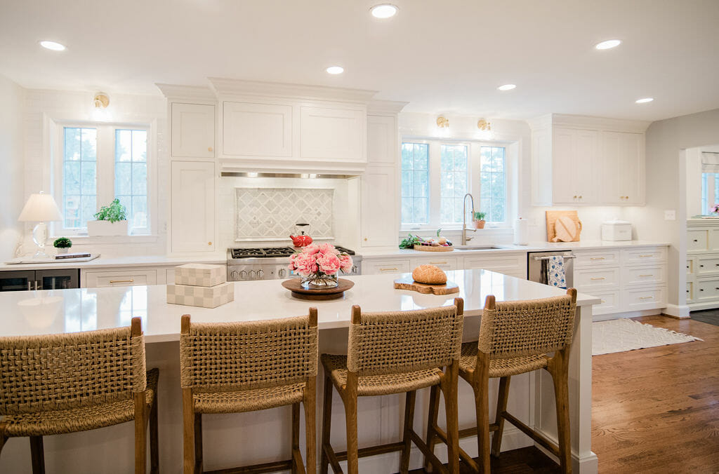 bright white kitchen with rustic chairs