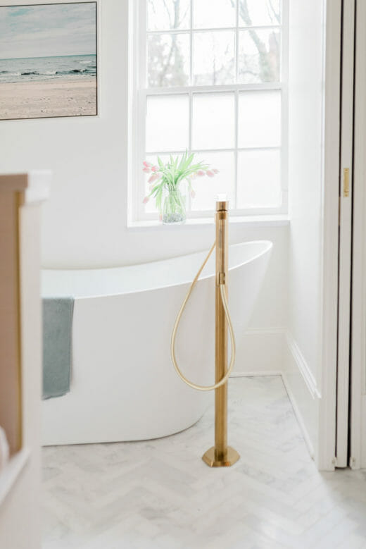 vintage white bathtub with gold fixtures