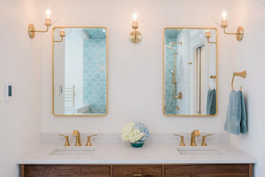 Charleene's-Houses-MD-baltimore-master-bath-renovation-double-vanity-wood-vanity-brass-faucets-brass-medicine-cabinets-brass-sconces-brass-towel-ring-scalloped-shower-tile